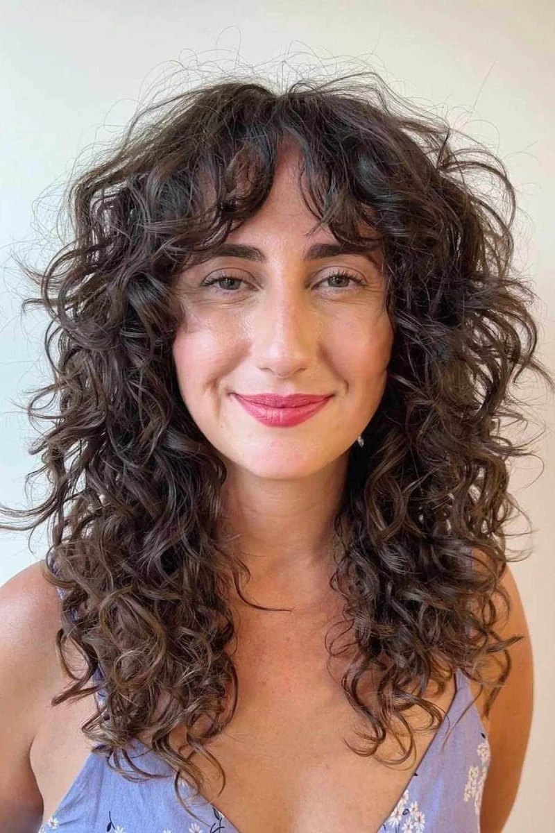 Curly hair with wispy curtain bangs