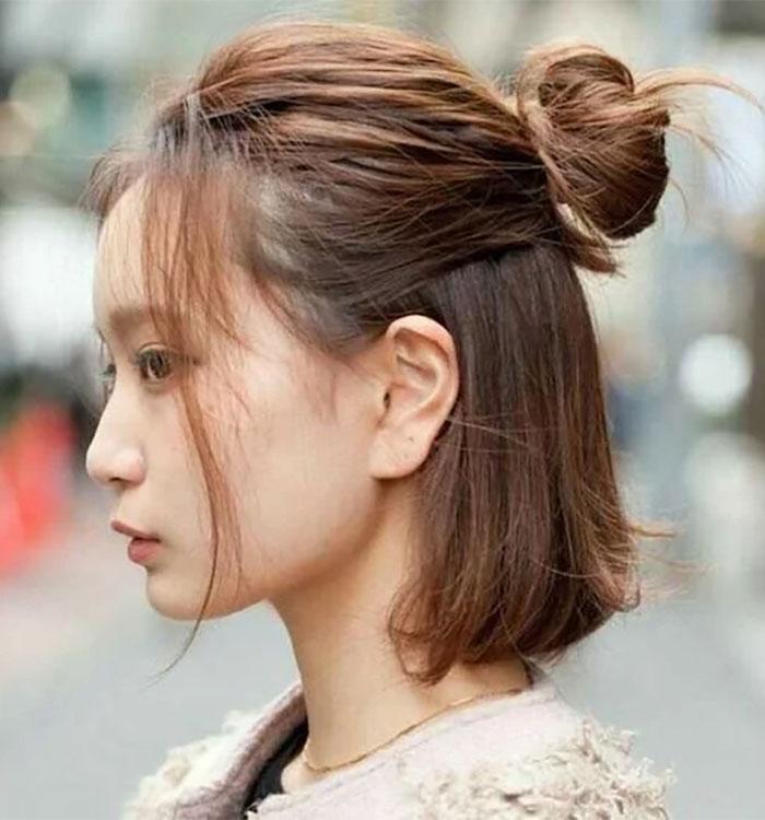 Half up bun face framing layers