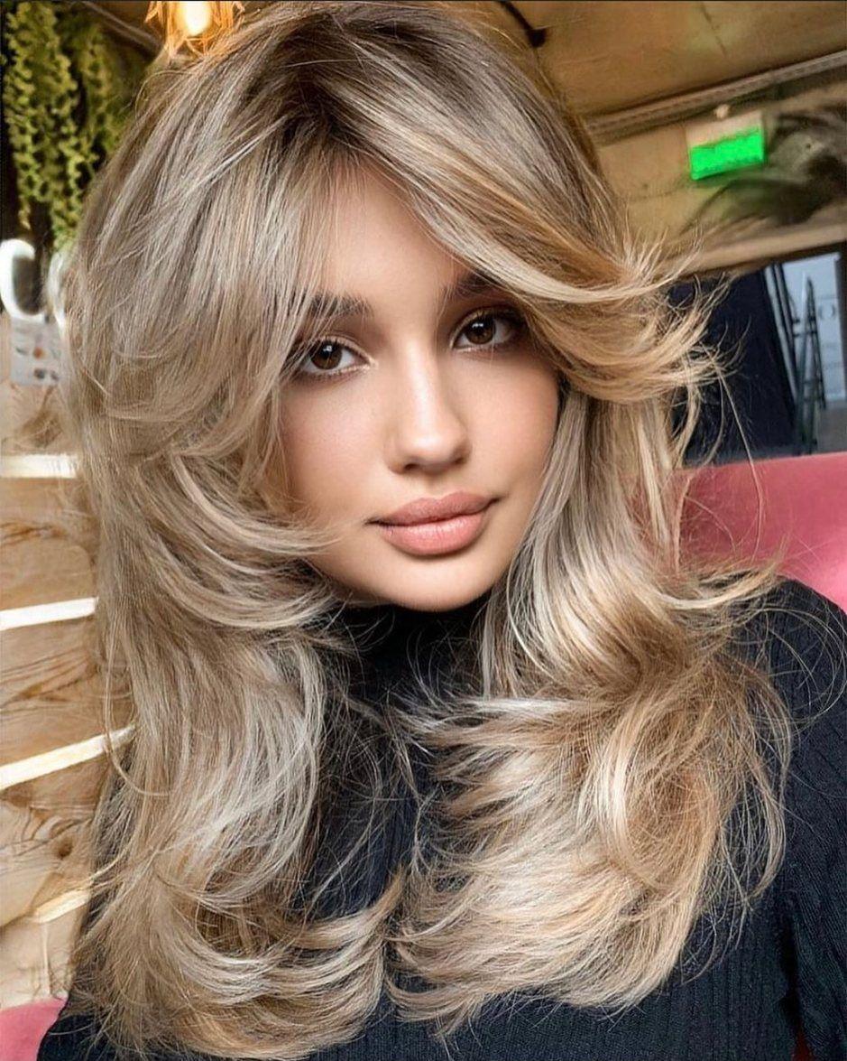 Champagne blonde layered blowout haircut with long layers
