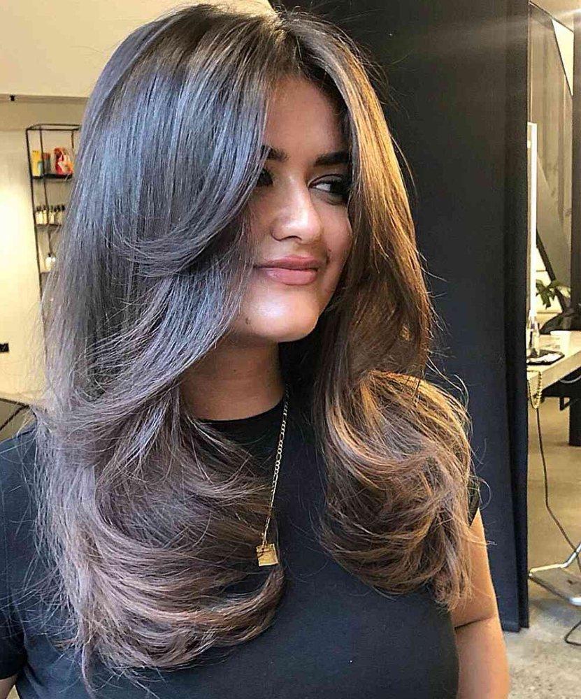 Full layered blowout haircut with dramatic salon volume