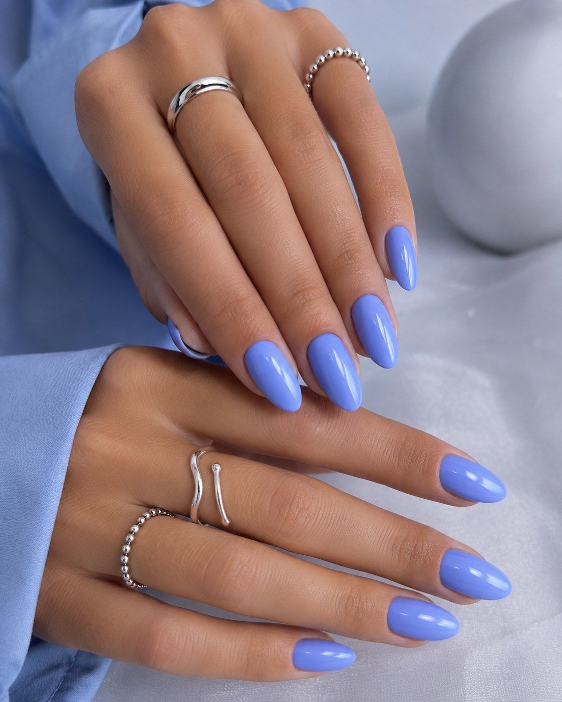 Glossy periwinkle blue pastel nails for a bold spring manicure