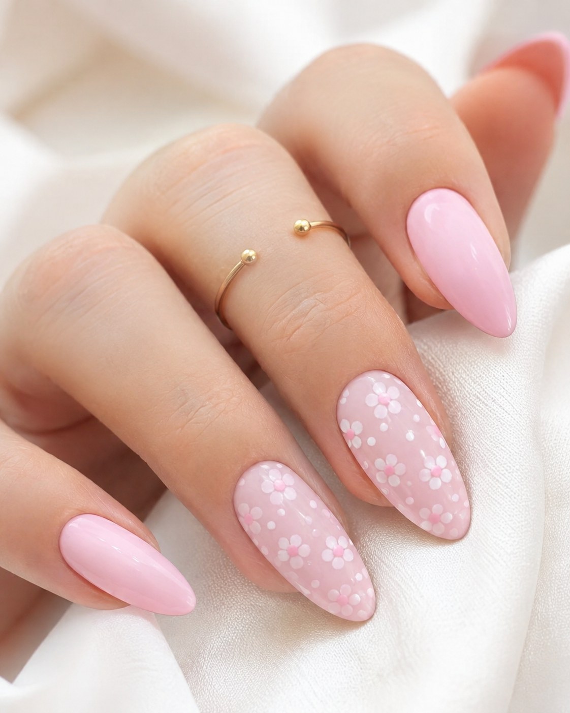 Soft pink pastel nails with a white daisy flower accent nail for spring