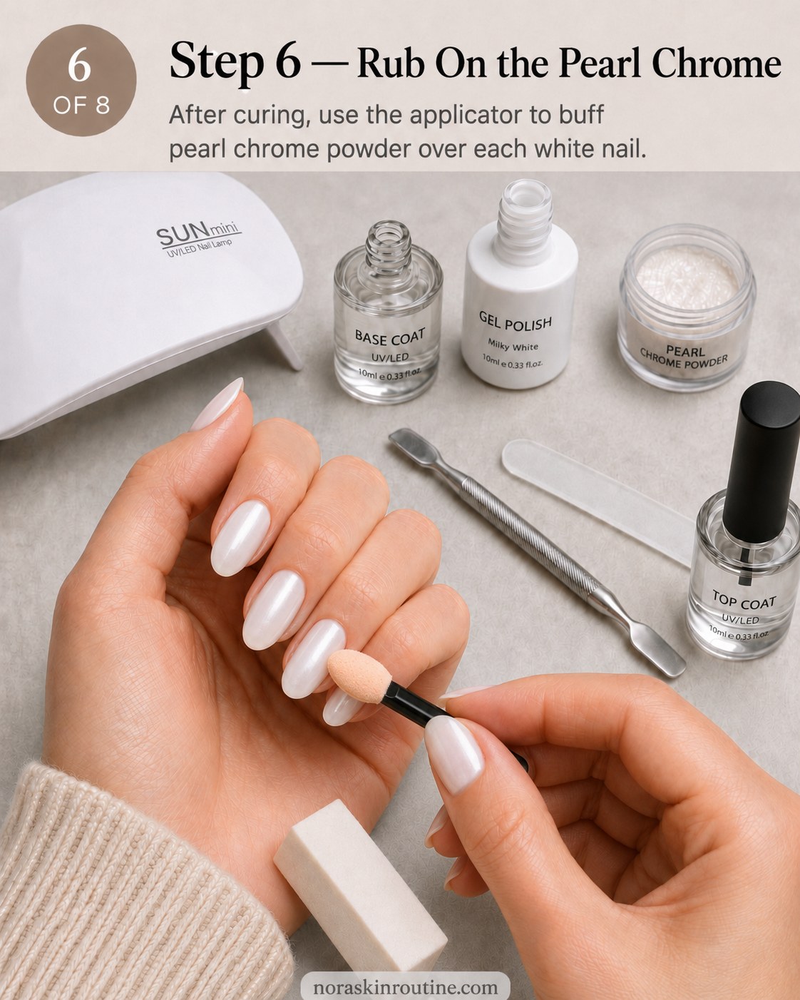 Buffing pearl chrome powder onto cured white nails with a foam sponge applicator