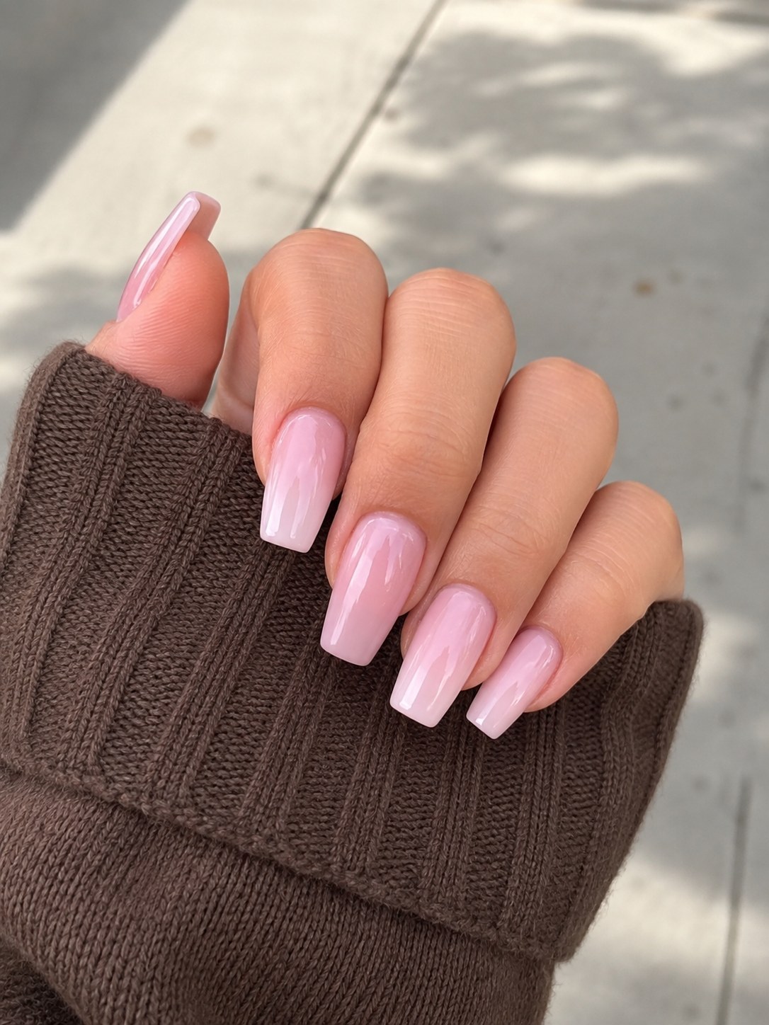 Medium-short coffin shaped nails with a milky pink ombre gradient and glossy top coat