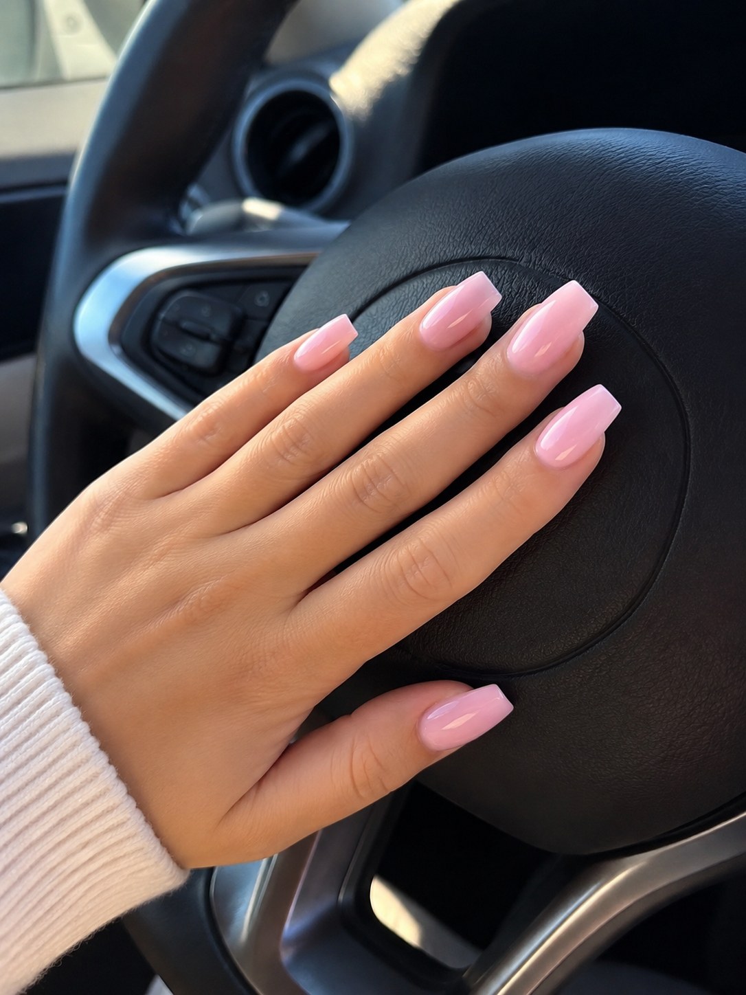 Short square coffin nails painted in a solid glossy bubblegum pink shade