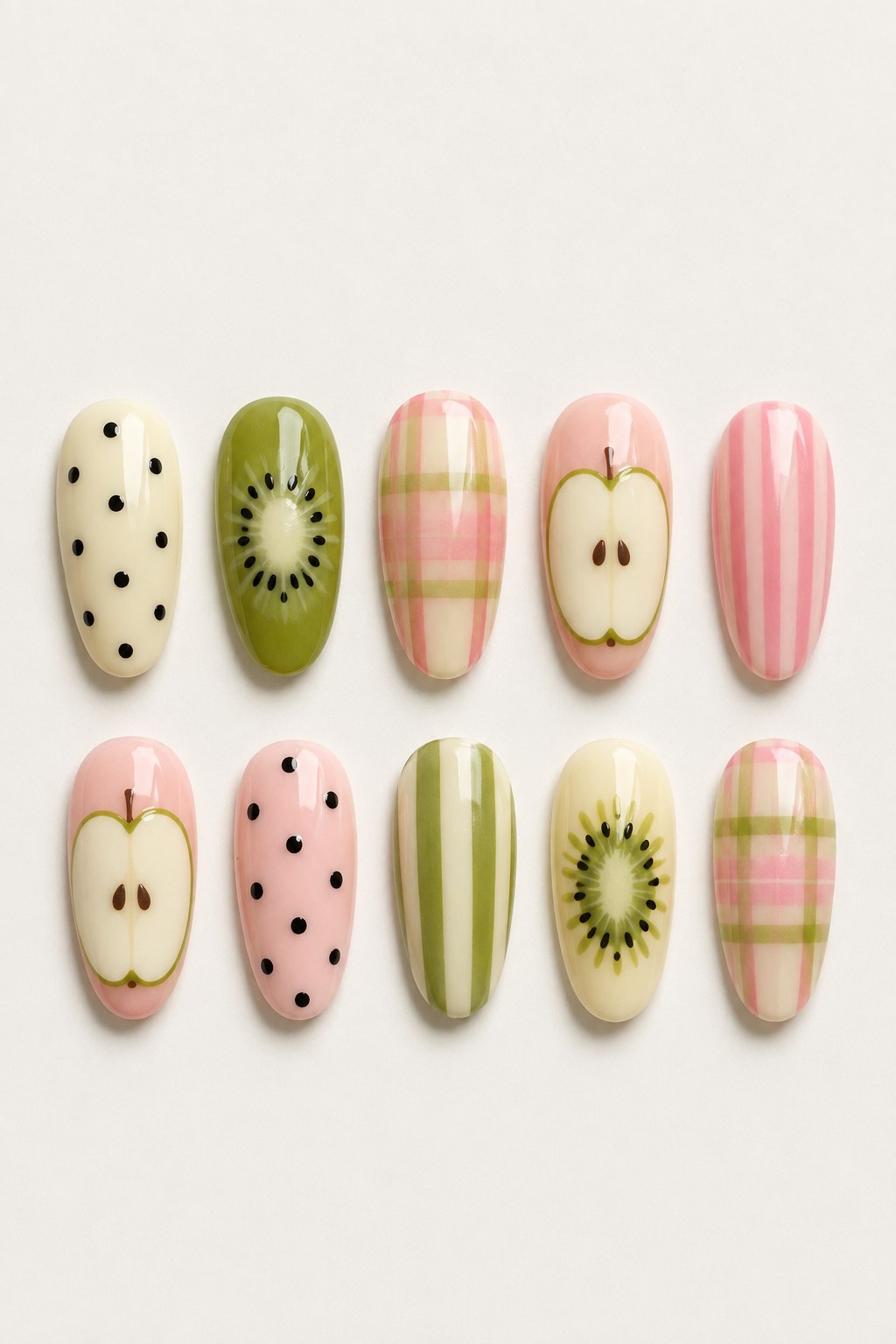 Polka dot nail art mixed with kiwi, apple, and plaid prints on a press-on set