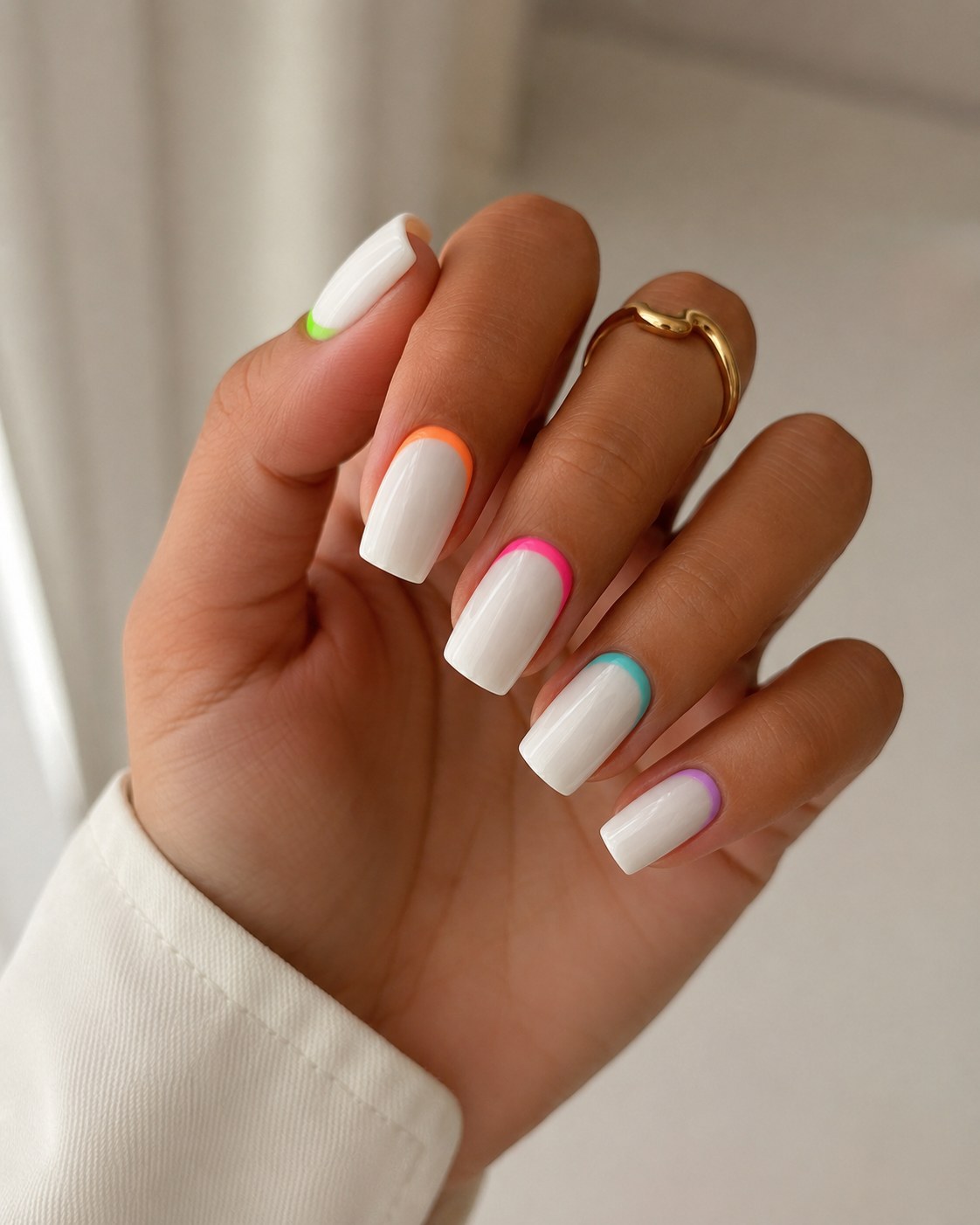 Short summer nails with a glossy white base and thin neon outlines in different colors on each nail