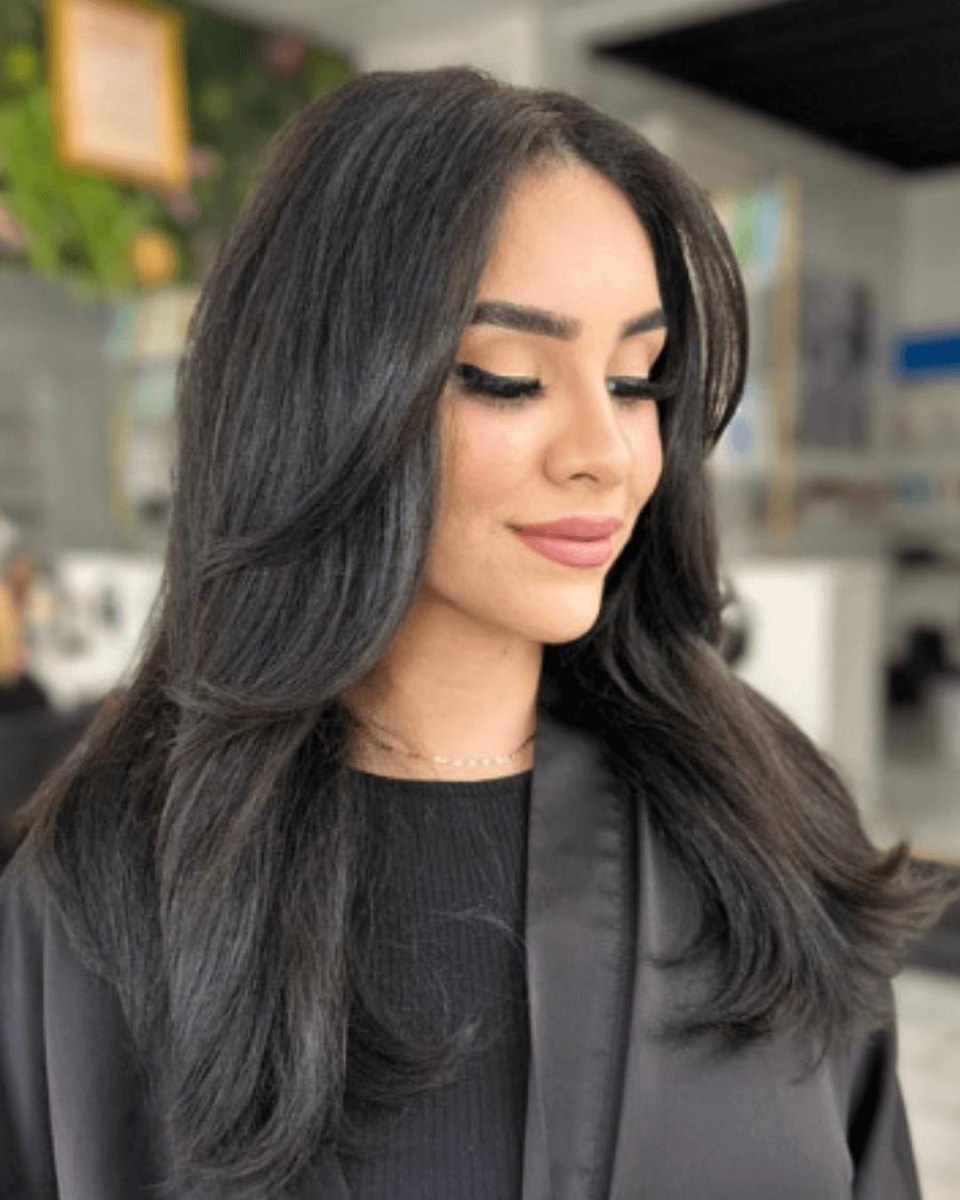Curly layered blowout haircut with rounded shape