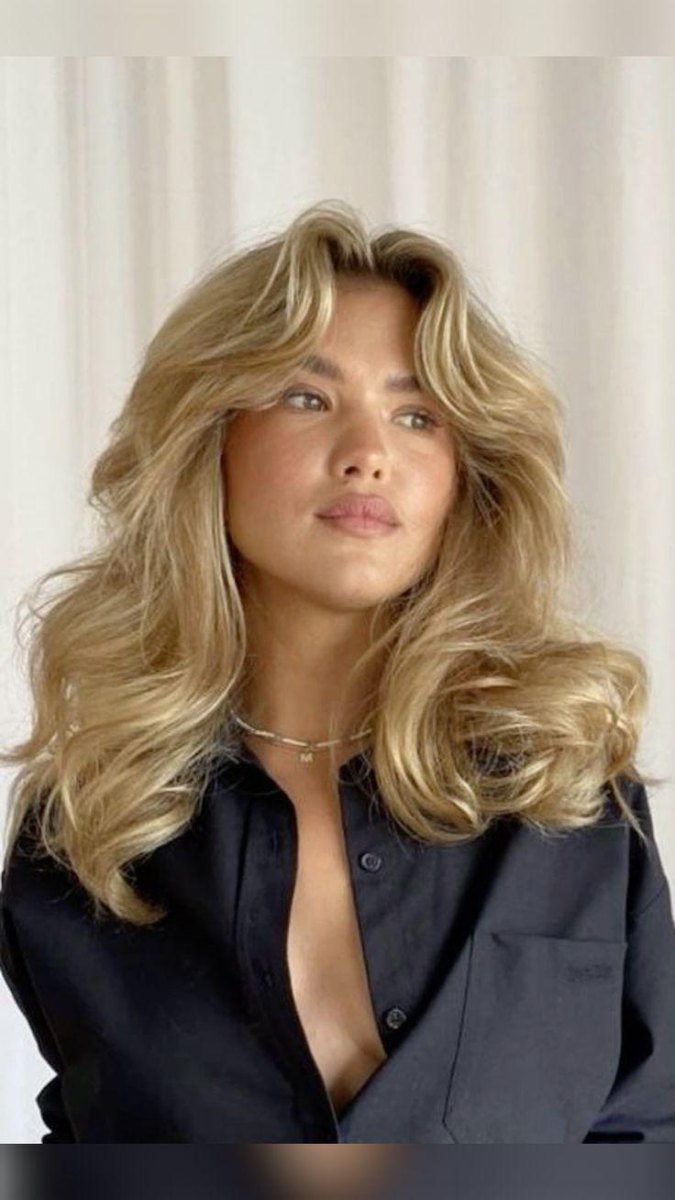 Curtain bangs layered 90s blowout hairstyle