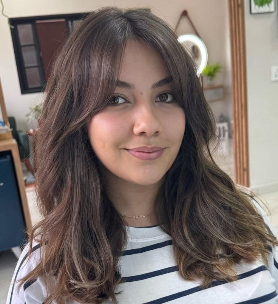 Soft wispy curtain bangs on oval face