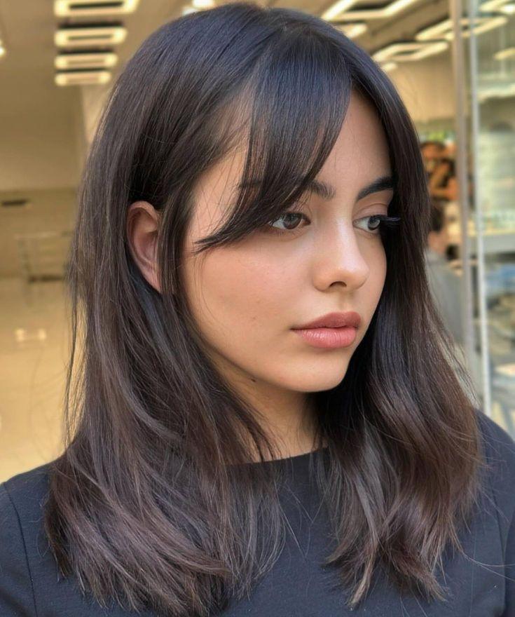 Medium length hair with wispy curtain bangs