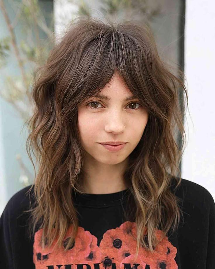Shag haircut with wispy curtain bangs